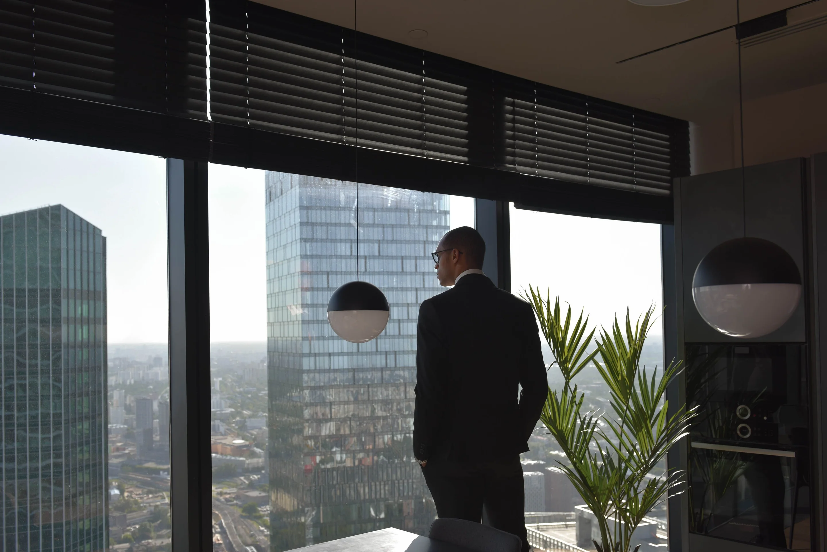 Executive looking out over office towers